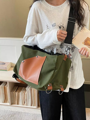Green nylon crossbody bag with contrast brown pocket and silver hardware.