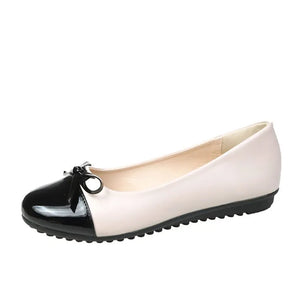 Patent bow ballet flats in black and white with a patent toe cap and bow detail.