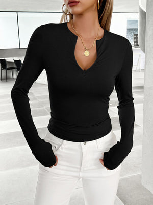 Black long sleeve contour zip top with plunging neckline and thumbholes.
