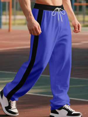 Men's royal blue wide-leg sweatpants with black side stripe and drawstring.