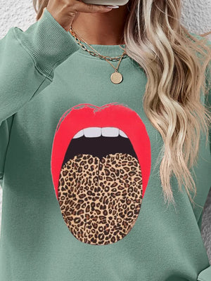 Sage sweatshirt with red lips and leopard tongue graphic.