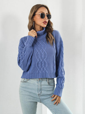 Blue cable knit cropped turtleneck pullover sweater with chunky knit details.