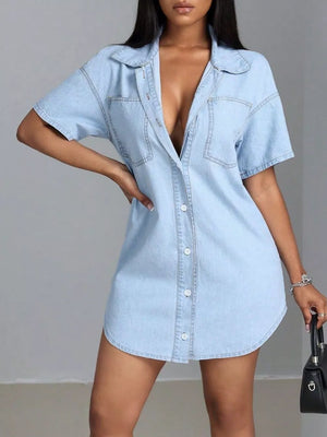 Light blue denim shirt dress with short sleeves, collared neckline, button front, and chest pockets.
