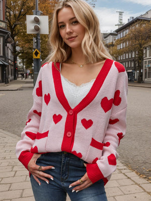 Love Letter Intarsia Knit Cardigan in pink with red hearts, v-neck, button front, and pockets.