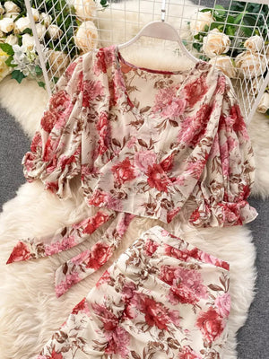 Chic floral two-piece crop set with puff sleeves and a tie-front top in pink and red floral print.