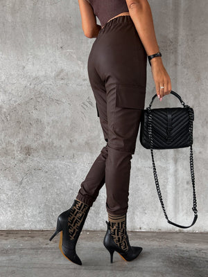Chocolate cargo joggers with elasticated waist and cuffed ankles, featuring utility pockets.