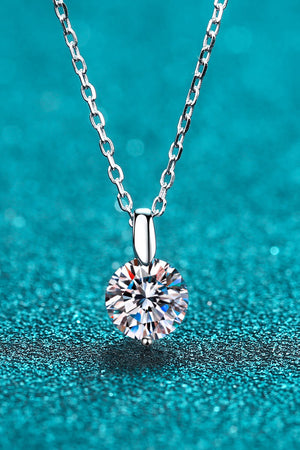 Silver solitaire moissanite pendant necklace with a round cut diamond.
