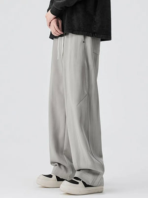 Light gray jogger pants with drawstring and pockets.