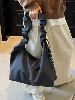Gray ruched nylon shoulder bag with zipper and drawstring detail