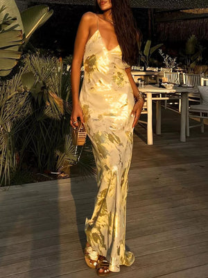 Elegant backless v-neck maxi gown in cream with abstract pattern.