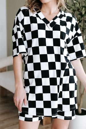 Black and white checkered V-neck t-shirt and shorts outfit set with short sleeves.