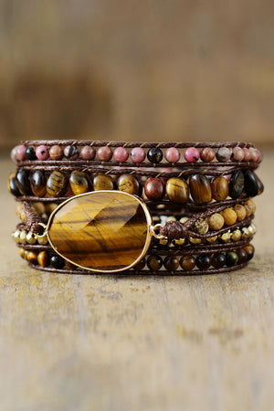 Wrap bracelet stack with tiger eye stone and brown cord, featuring assorted beads.