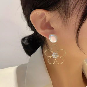 Gold floral drop earrings with pearl accent and crystal center.