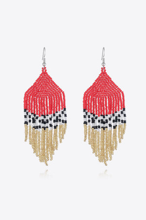 Geometric fringe beaded earrings in red, black, white, and gold with a boho style.