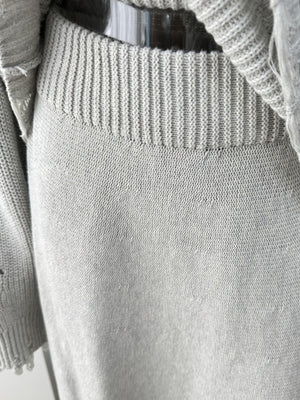 Light gray distressed cotton sweater set with ribbed neckline and deconstructed details.