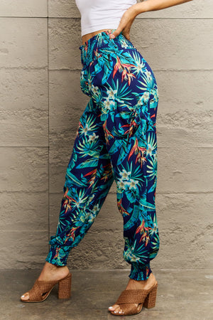 Tropical print cargo pants with gathered cuffs and a smocked waistband.