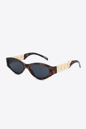 Tortoiseshell cat-eye sunglasses with gold chain detail on temples
