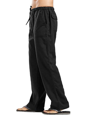Black linen drawstring trousers with pockets and a relaxed fit.
