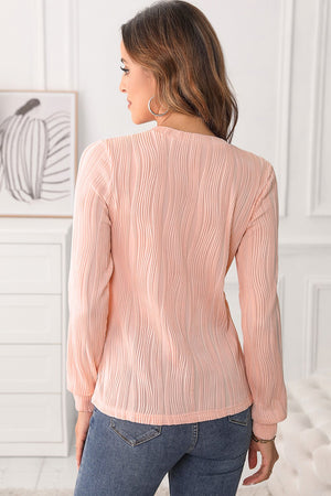 Textured wave crewneck pullover in blush pink with long sleeves and a crew neckline.