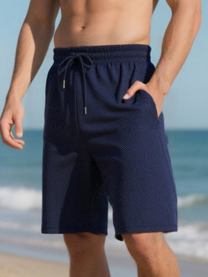 Navy blue chino shorts with drawstring and textured pattern, relaxed fit.