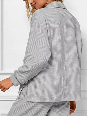 Gray textured lounge set with diagonal pattern, V-neck top and matching pants.