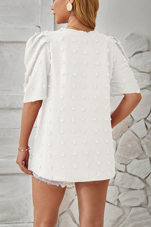 White textured puff-sleeve blouse with pom-pom details and a relaxed fit.