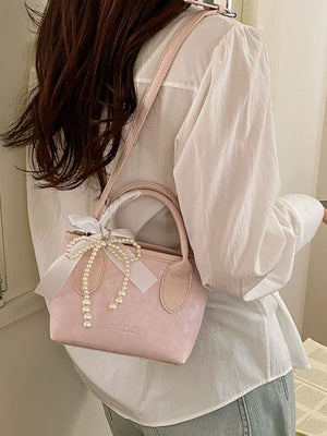 Pearl Bow Charm Crossbody Bag in Blush Pink, model styling view