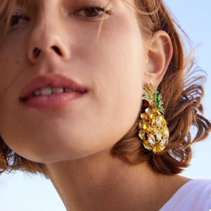 Pineapple-inspired dangle earrings with yellow and green rhinestones.
