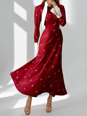 Burgundy midi dress with contrast collar, long sleeves, defined waist, and subtle white pattern.