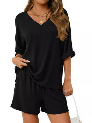 Black V-neck loungewear set with ribbed texture and cuffed sleeves.