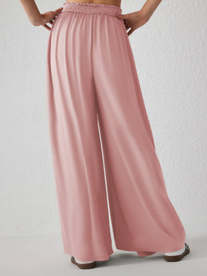 Drape-front wide-leg jersey trousers in watermelon pink with smocked waistband.