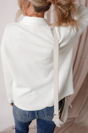 Textured corduroy overshirt in white with a collar and button front, styled with jeans.
