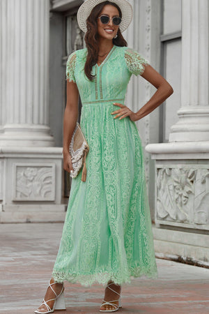 Mid green lace midi dress with scalloped hem and short sleeves.