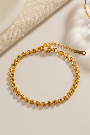 Gold linked heartbeat chain bracelet with lobster clasp and extender.