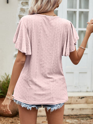 Blush pink eyelet blouse with flutter sleeves and a textured pattern.