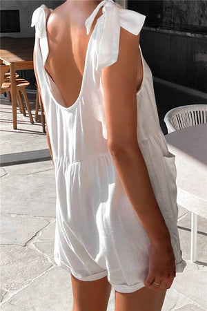 White romper with bow shoulder straps and gathered waist