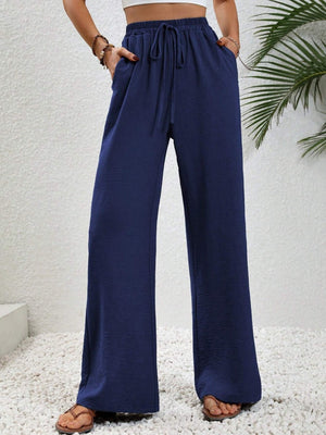 Dark blue textured palazzo trousers with drawstring waist and pockets