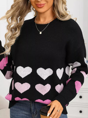 Black crew neck sweater with allover heart print in pink and white, acrylic knit.