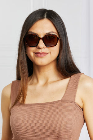 Brown tortoiseshell hexagonal frame sunglasses with acetate material.