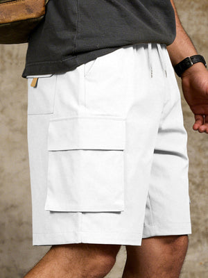White cargo shorts with drawstring waist and large flap pockets.
