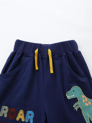 Navy cotton baby pants with dinosaur and ROAR embroidery, yellow drawstring.