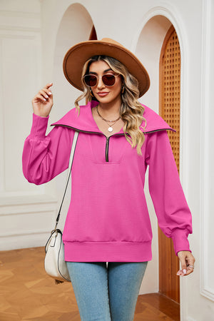 Fuchsia pink zip-through sweatshirt with wide collar and balloon sleeves.