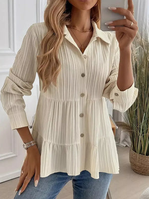 Cream textured tiered button-down shirt with crinkled fabric and button details.