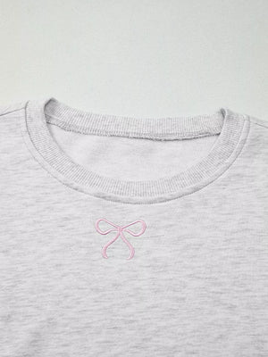 Gray crewneck sweatshirt with pink bow embroidery