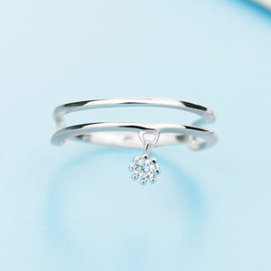 Sterling silver double layered ring with a dangling crystal charm.