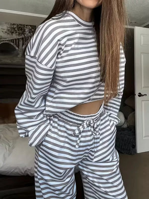 Chic striped two-piece lounge set in light gray and white with drawstring pants and long sleeves.