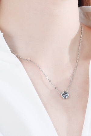 Solitaire bezel-set diamond necklace in silver with a delicate chain.