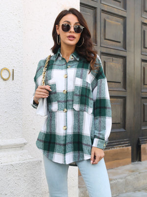 Oversized green plaid shacket with gold buttons and chest pockets.