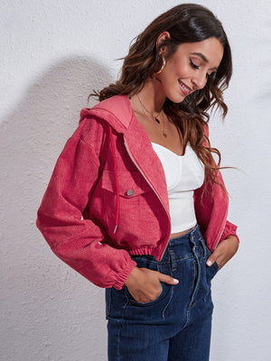 Cropped corduroy hooded jacket in hot pink with zip front and drawstring hood.