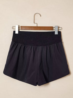 Black jogger shorts with a ribbed high waistband and elasticated fit.